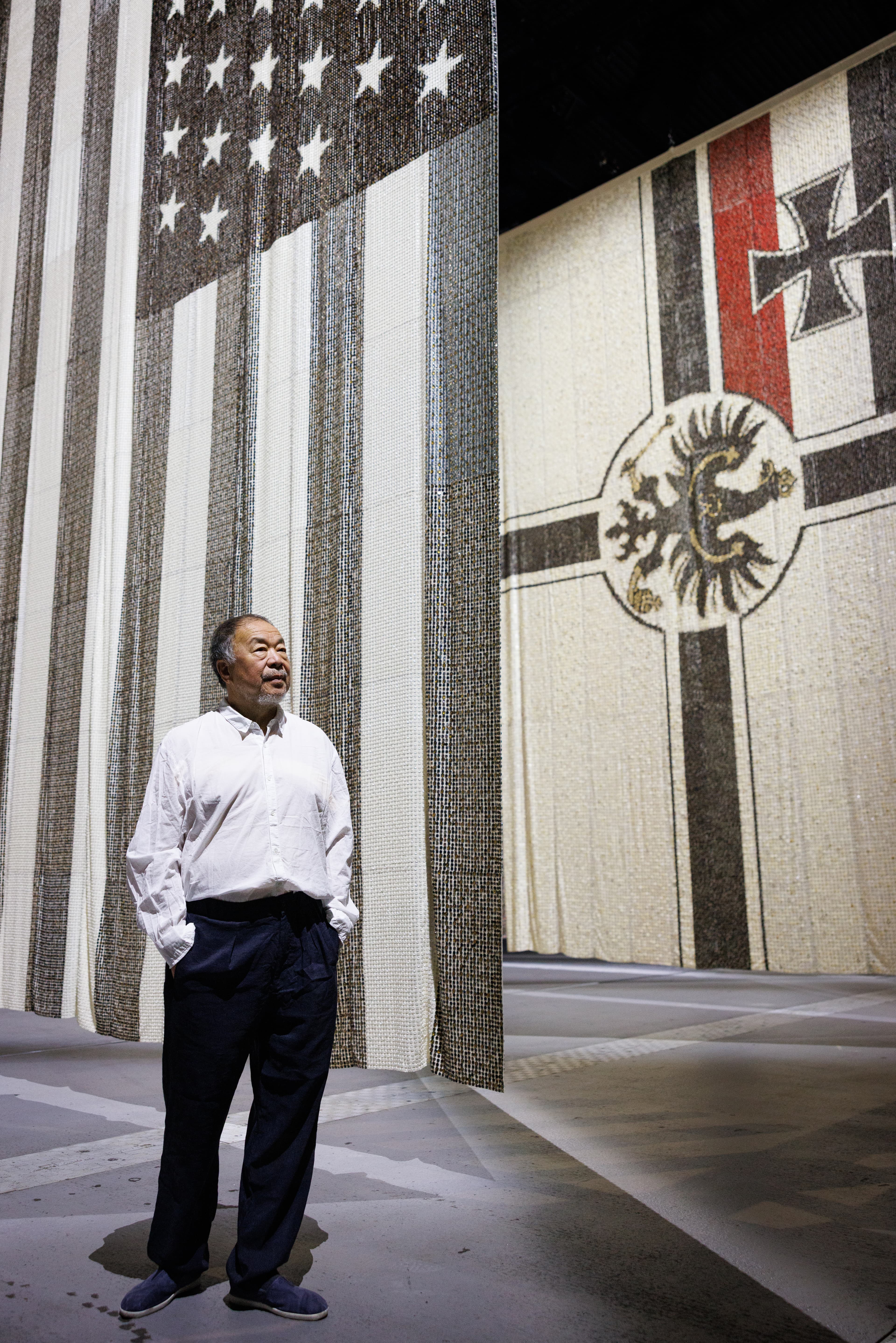 Ai Weiwei standing inside a large gallery installation at Factory International.