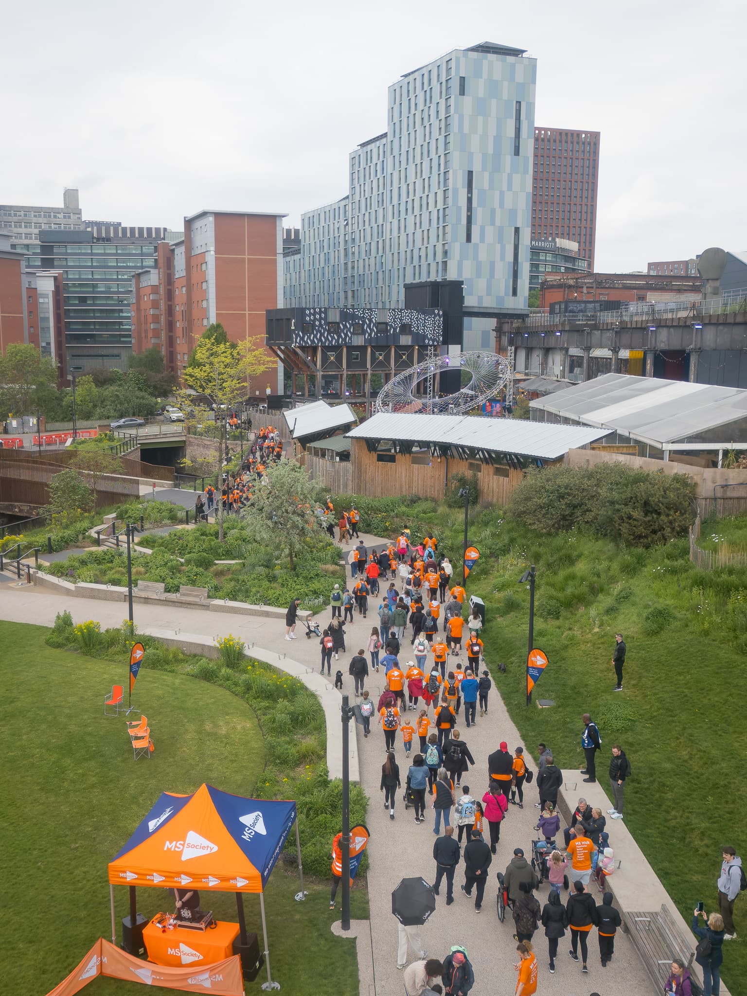 Drone photograph of a public walk event through a city park.