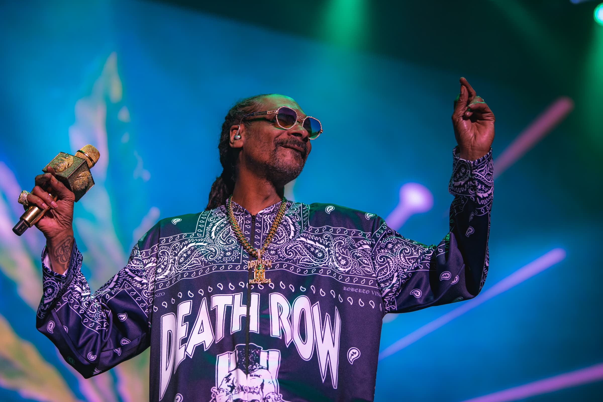 Snoop Dogg performing live at AO Arena in Manchester under colourful stage lights.