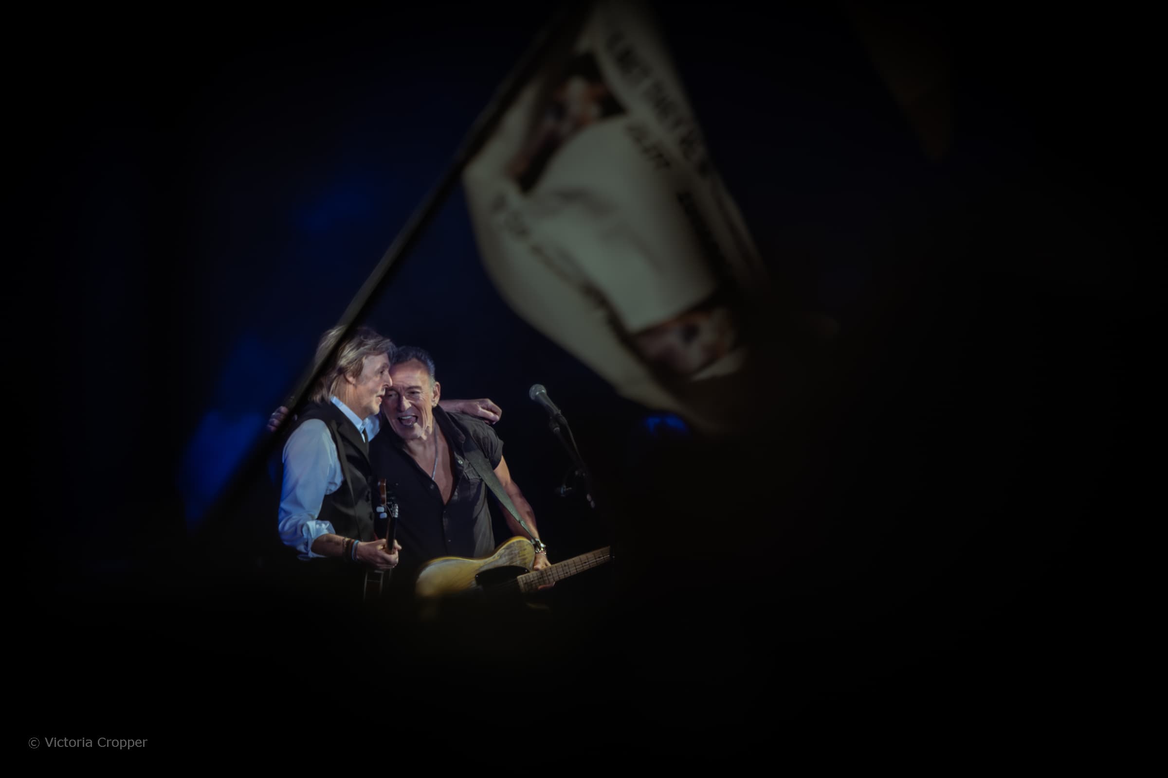 Paul McCartney and Bruce Springsteen performing together at Glastonbury Festival.