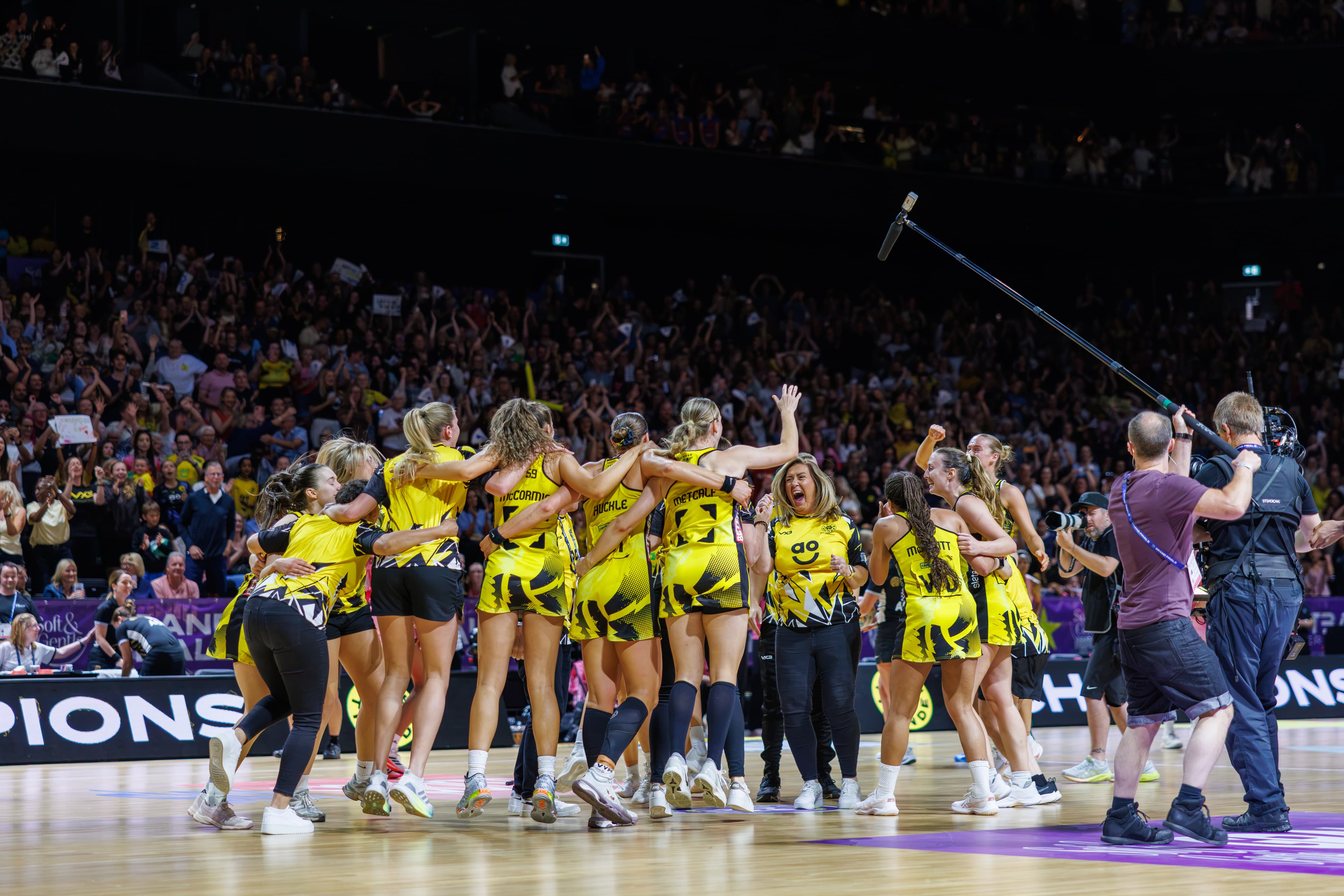 Netball team lifting the trophy during a wide celebration at the 2026 Netball Super League Final.