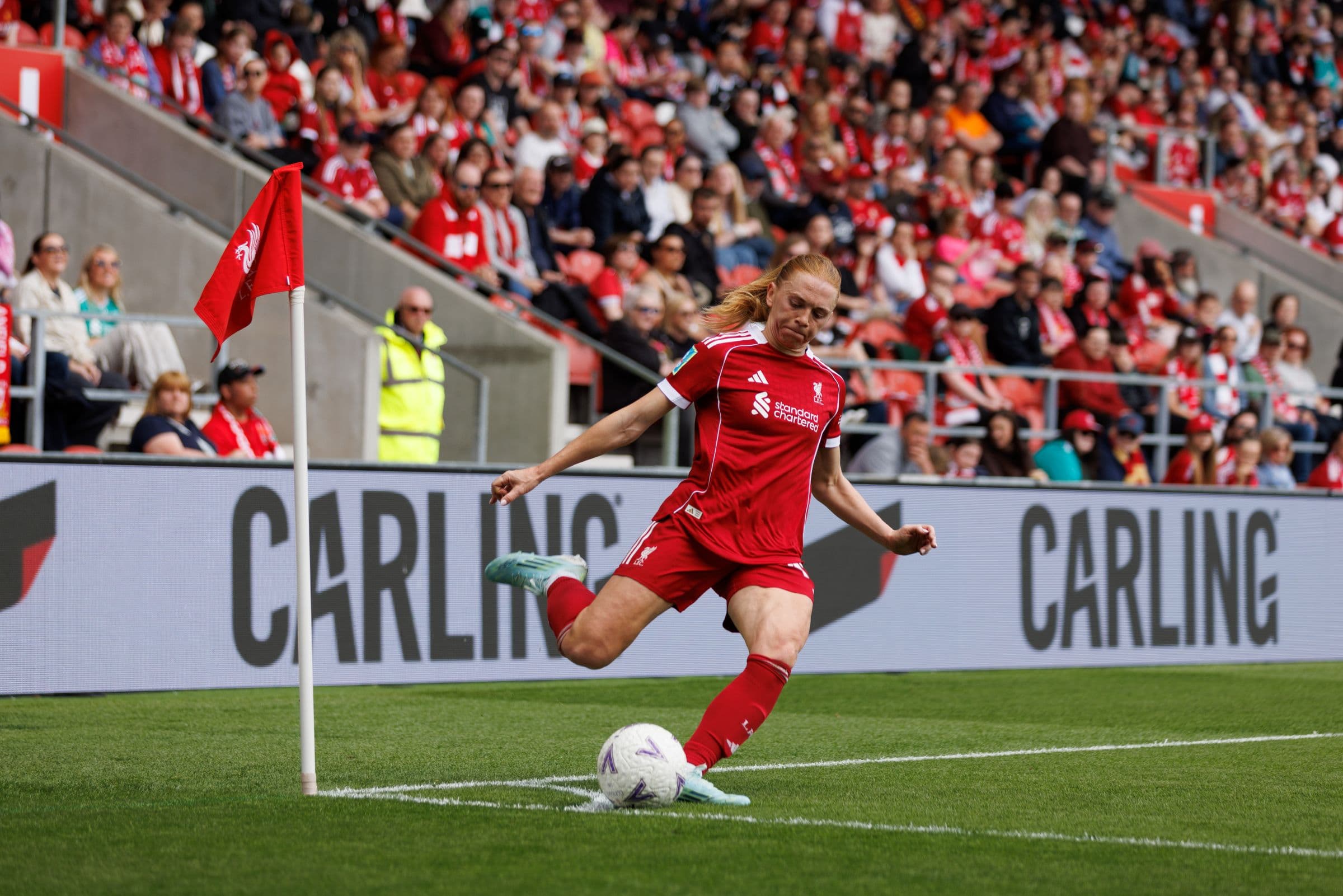 Footballer taking a corner during a live match.