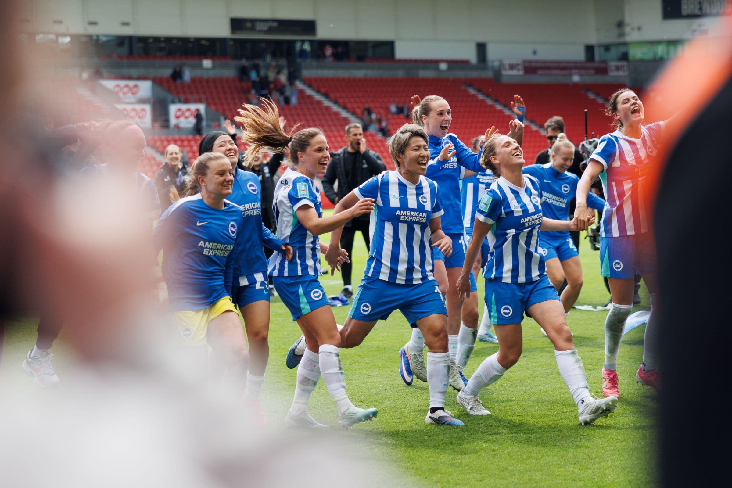 Football team celebrating together on the pitch.