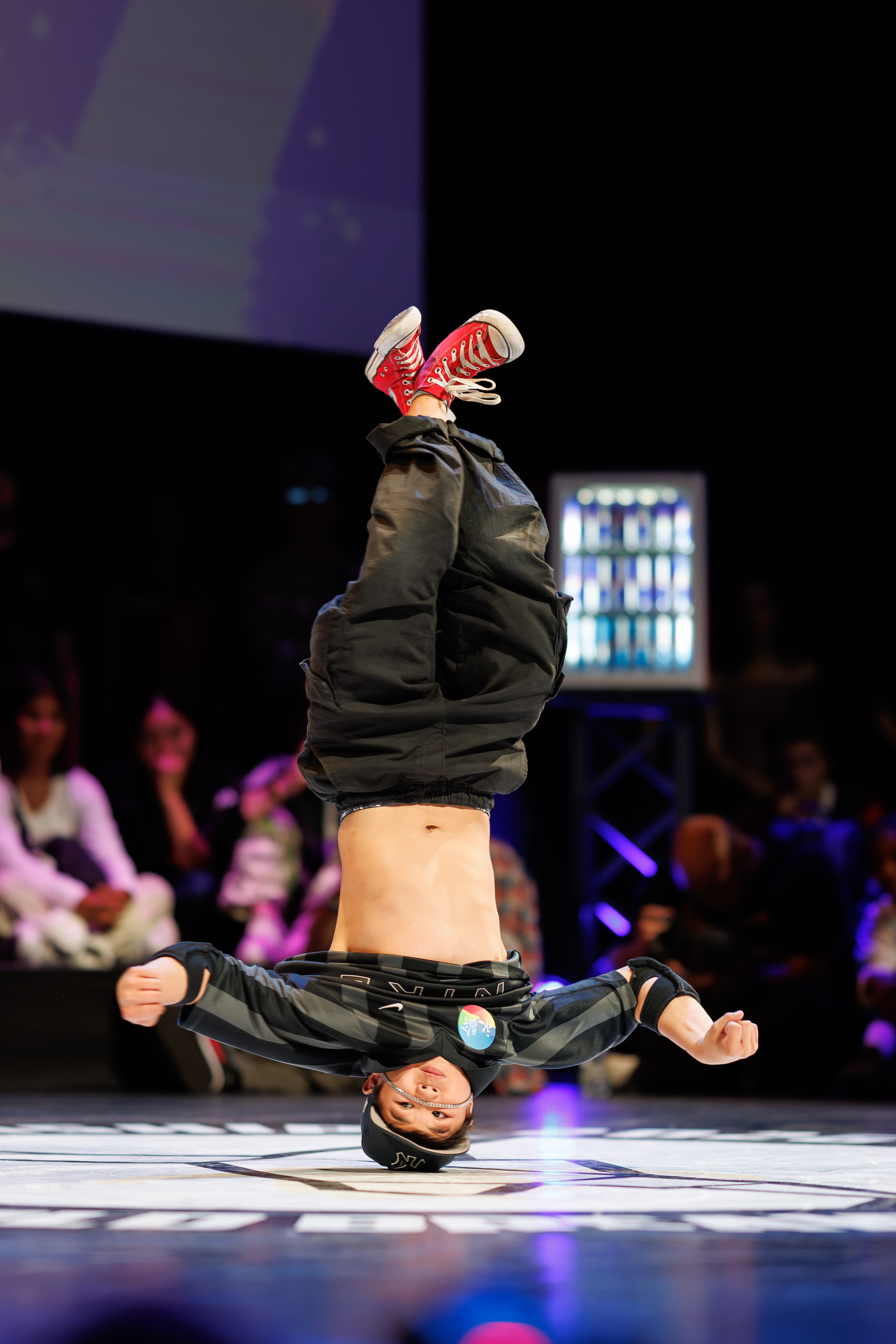 A breaker upside down during a floor move at the Breaking Finals.